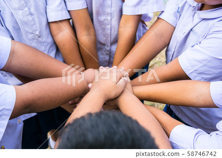 School children use hand-to-hand coordination to combine power in activities. School children use hand-to-hand coordination to combine power in activities. 58746742