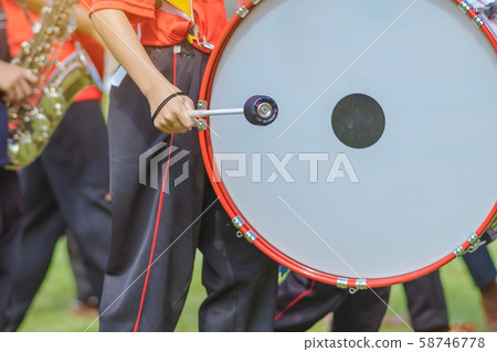 Marching band bass drummers perform in school parade Marching band bass drummers perform in school parade 58746778