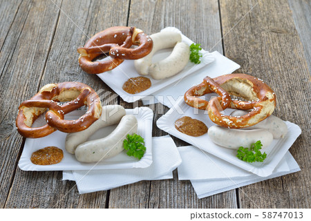 Bavarian street food: Munich white sausages with a fresh pretzel and sweet mustard on a paper plate Bavarian street food: Munich white sausages with a fresh pretzel and sweet mustard on a paper plate 58747013