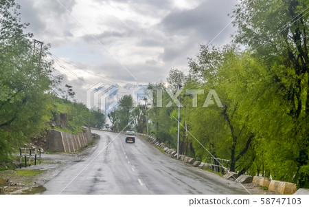 Perfect asphalt mountain road overcast rainy day 58747103