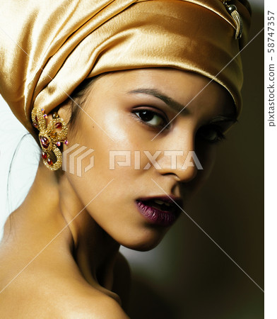 beauty african woman in shawl on head, very elegant look with gold jewelry close up mulatto makeup beauty african woman in shawl on head, very elegant look with gold jewelry close up mulatto makeup 58747357