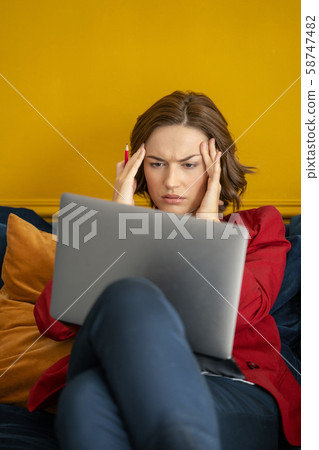 Exhausted beautiful young woman suffering from headache 58747482
