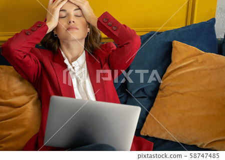 Exhausted stylish woman relaxing on the sofa Exhausted stylish woman relaxing on the sofa 58747485