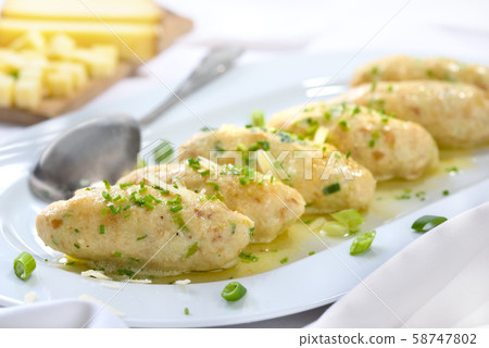 Tyrolean cheese dumplings (Kasnocken)  served with butter and parmesan 58747802