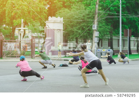 Group of elderly friend doing aerobic dance after work   together at Lumpini Park in Bangkok, Thailand. 58749295