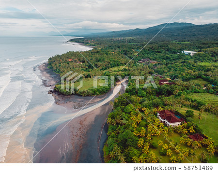 Aerial view of black sand beach with river, ocean and waves in Balian, Bali 58751489