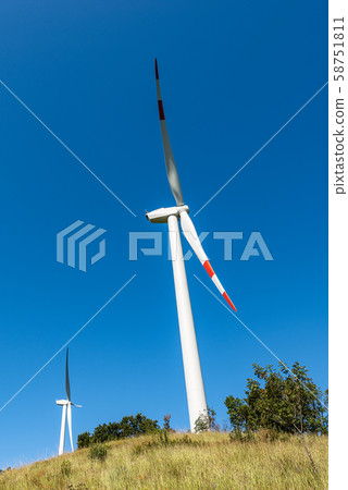 Two wind turbines above the hill - Renewable energy Two wind turbines above the hill - Renewable energy 58751811