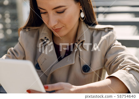 Attentive girl bowing head while reading message 58754640