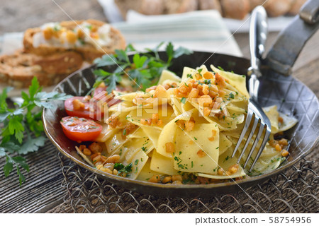 Austrian cuisine: Roasted square shaped pasta with bacon cracklings (so-called 'Grammelfleckerl')  58754956