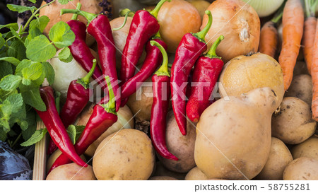 Appetizing red hot pepper lies on a potato on the counter 58755281