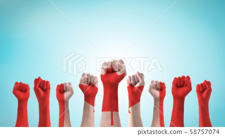 Labour day celebration with Canada national flag pattern on Canadian people clenched fist hand isolated on sky background for labor day holiday 58757074