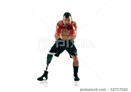 Full length portrait of muscular sportsman with prosthetic leg, copy space. Male boxer in red gloves Full length portrait of muscular sportsman with prosthetic leg, copy space. Male boxer in red gloves 58757083