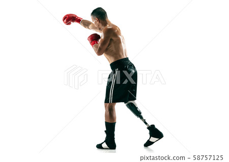 Full length portrait of muscular sportsman with prosthetic leg, copy space. Male boxer in red gloves 58757125