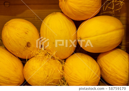 Juicy beautiful yellow melon lies in a cardboard 58759170