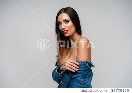 Beautiful caucasian girl in a denim jacket posing Beautiful caucasian girl in a denim jacket posing 58759199