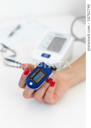 doctor puts a heart rate monitor on a patients doctor puts a heart rate monitor on a patients 58762746