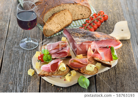 South Tyrolean bacon snack with fresh stone oven baked bread and mountain cheese 58763193