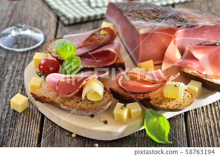 South Tyrolean bacon snack with fresh stone oven baked bread and mountain cheese 58763194