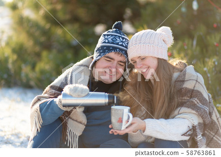 Young couple in love drink a hot drink from a 58763861