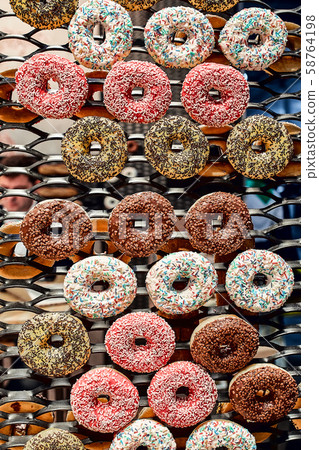 Colorful glazed donuts on a wire rack Colorful glazed donuts on a wire rack 58764198