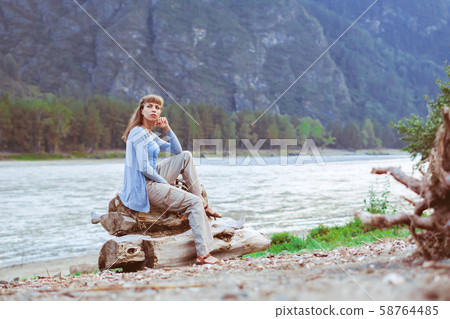 girl sitting by the river girl sitting by the river 58764485