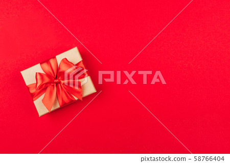 Cardboard gift box with bow on red background. Cardboard gift box with bow on red background. 58766404