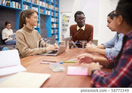 Team of Students Discussing Project in Library Team of Students Discussing Project in Library 58771549