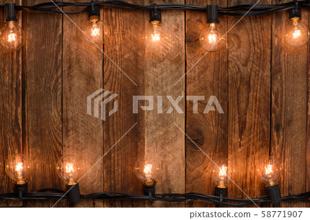 Vintage garland on old rustic wooden wall background Vintage garland on old rustic wooden wall background 58771907