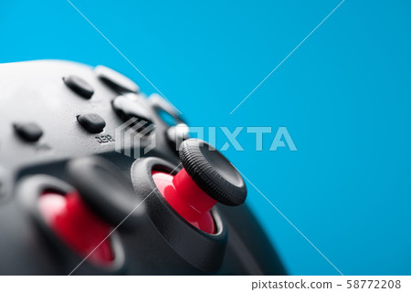 Gamepad video game controller retro toned on blue background Gamepad video game controller retro toned on blue background 58772208