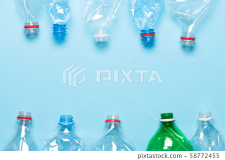 Plastic bottles on blue background top view. Recycle plastic waste pollution concept template. 58772455