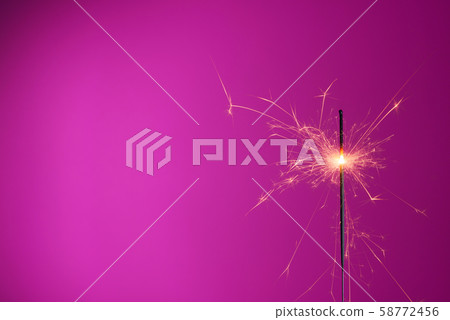 Sparkler on pink background with copy-space Sparkler on pink background with copy-space 58772456