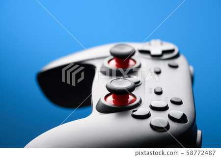 Game pad. Modern video game controller. Joy stick on blue background with copy-space. 58772487