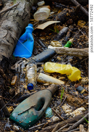 Plastic pollution muddy puddle with bottles waste and styrofoam on ocean beach. 58772492