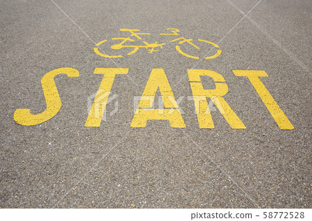 Bicycle road yellow paint start sign on asphalt Bicycle road yellow paint start sign on asphalt 58772528
