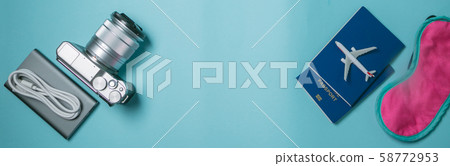 Traveling concept - traveling essencials on blue background Traveling concept - traveling essencials on blue background 58772953