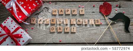 Valentine's day concept - presents, candy, glasses on rustic wood background 58772974