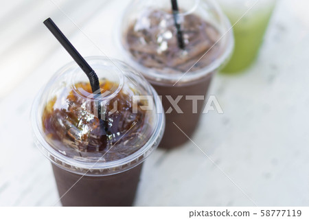 Close up glass of ice americano coffee on wood Close up glass of ice americano coffee on wood 58777119