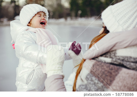 Mother and daughter in a winter park Mother and daughter in a winter park 58778086