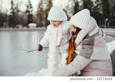 Mother and daughter in a winter park Mother and daughter in a winter park 58778089