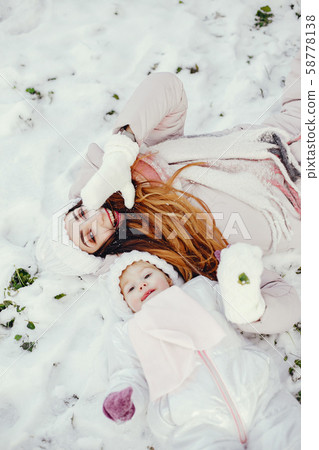 Mother and daughter in a winter park 58778138