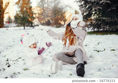Mother and daughter in a winter park 58778153
