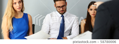 Group of people sit on casting chairs row at boss reception Group of people sit on casting chairs row at boss reception 58780006