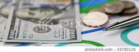 Silver pen lying on desk cash dollar plots Silver pen lying on desk cash dollar plots 58780126
