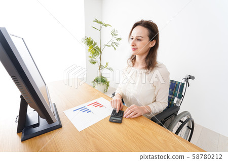 A foreign woman who works in a wheelchair A foreign woman who works in a wheelchair 58780212