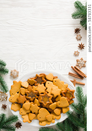 Plate full of freshly baked Christmas gingerbread ready to decorate with icing Plate full of freshly baked Christmas gingerbread ready to decorate with icing 58783331