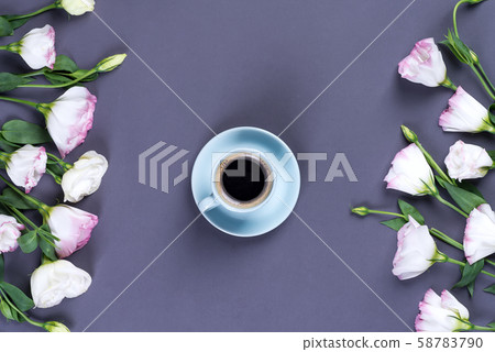 Blue cup of coffee with bouquet blooming pink 58783790