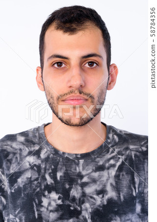 Face of young bearded Persian man looking at camera 58784356