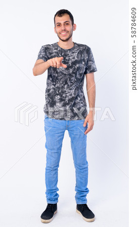 Full body shot of happy young bearded Persian man pointing at camera Full body shot of happy young bearded Persian man pointing at camera 58784609