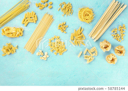 Italian pasta variety, flat lay banner, shot from the top on a blue background with a place for text 58785144