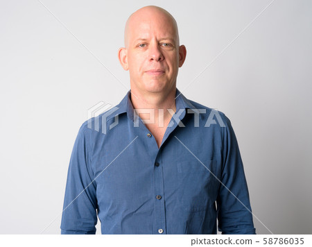 Face of mature handsome bald businessman looking at camera Face of mature handsome bald businessman looking at camera 58786035